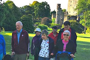 A group of Dave's friends on the grounds of Blarney Castle in Ireland with their guide dogs